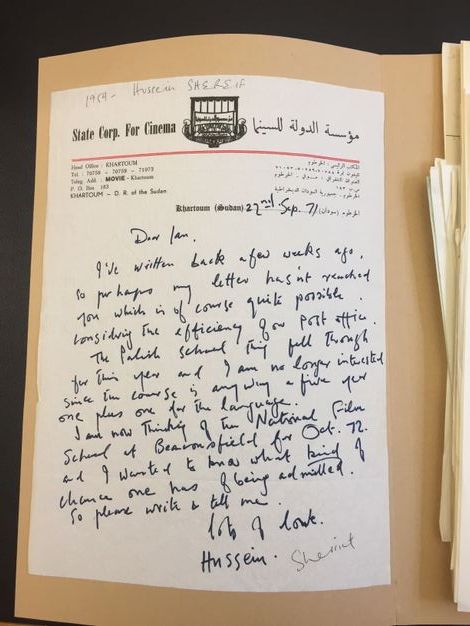 Letter. In blue handwritten ink, a letter begins, “Dear Ian, I've written back a few weeks ago…” and ends, “So please write and tell me. Lots of love, Hussein”. The letterhead reads “State Corp. For Cinema” to our left of a logo and Arabic writing is to the right.